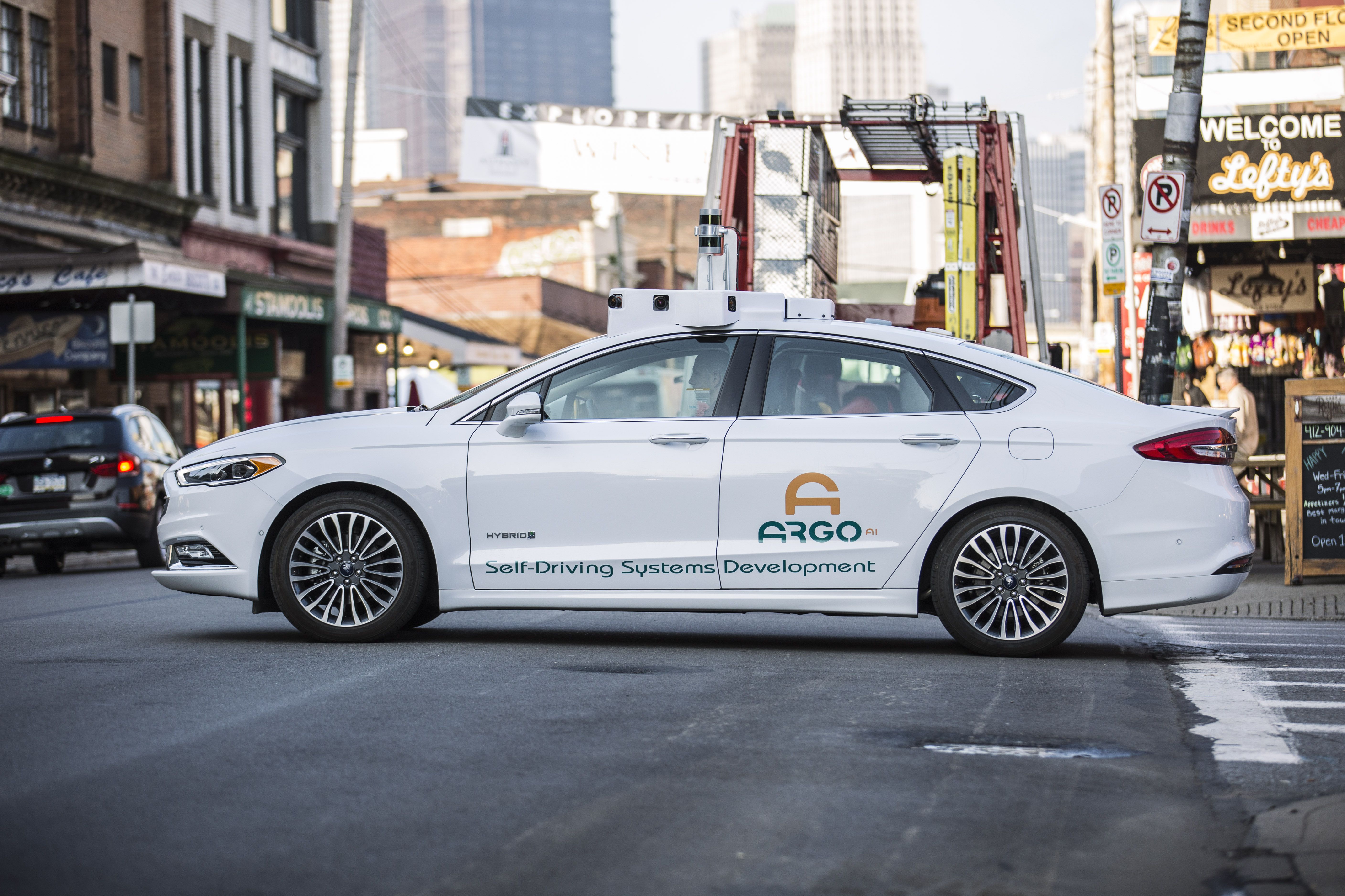 Um carro sem motorista da Ford com motor Argo AI opera com um motorista de segurança presente.