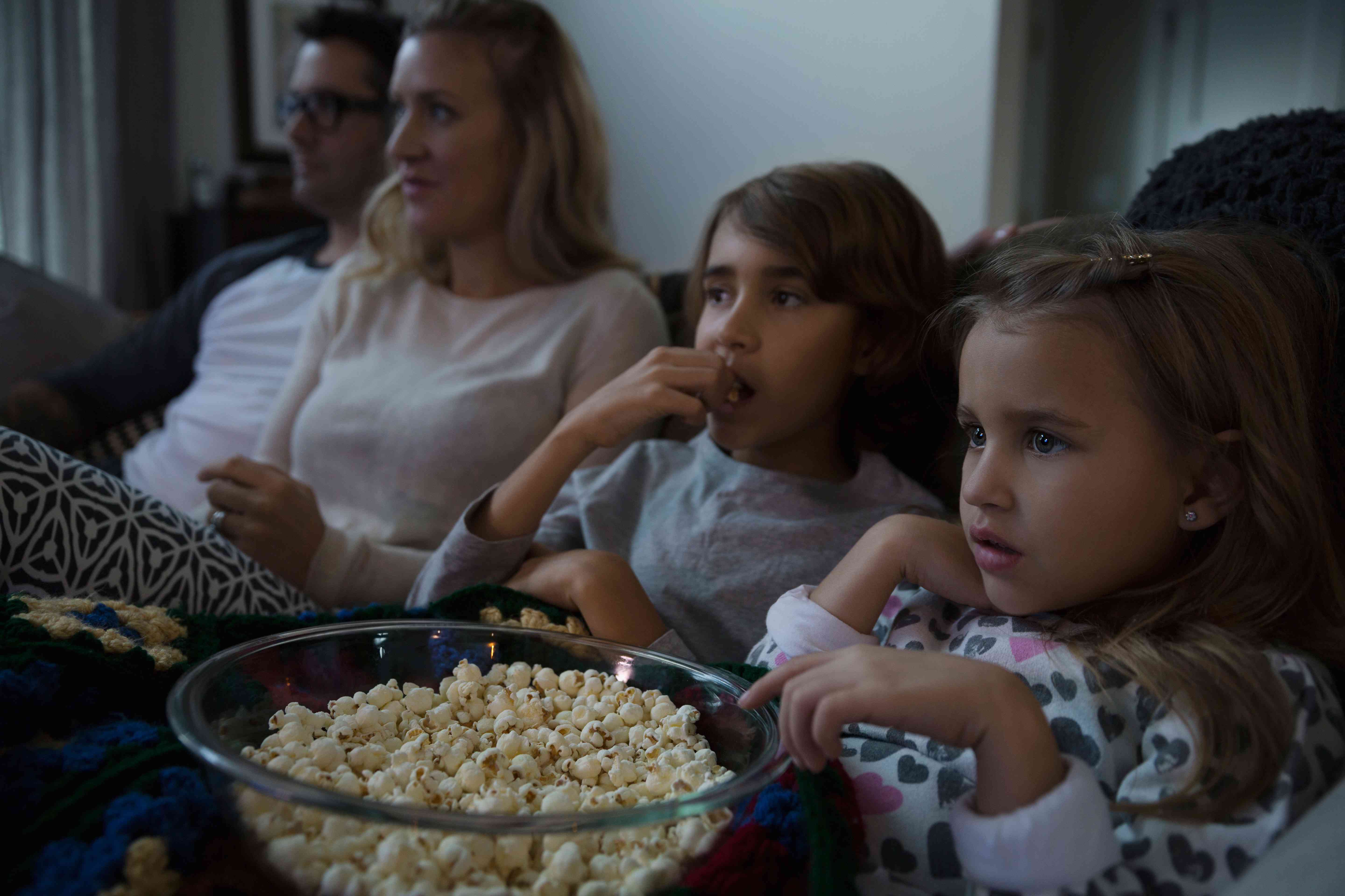 Família assistindo a um filme enquanto come pipoca